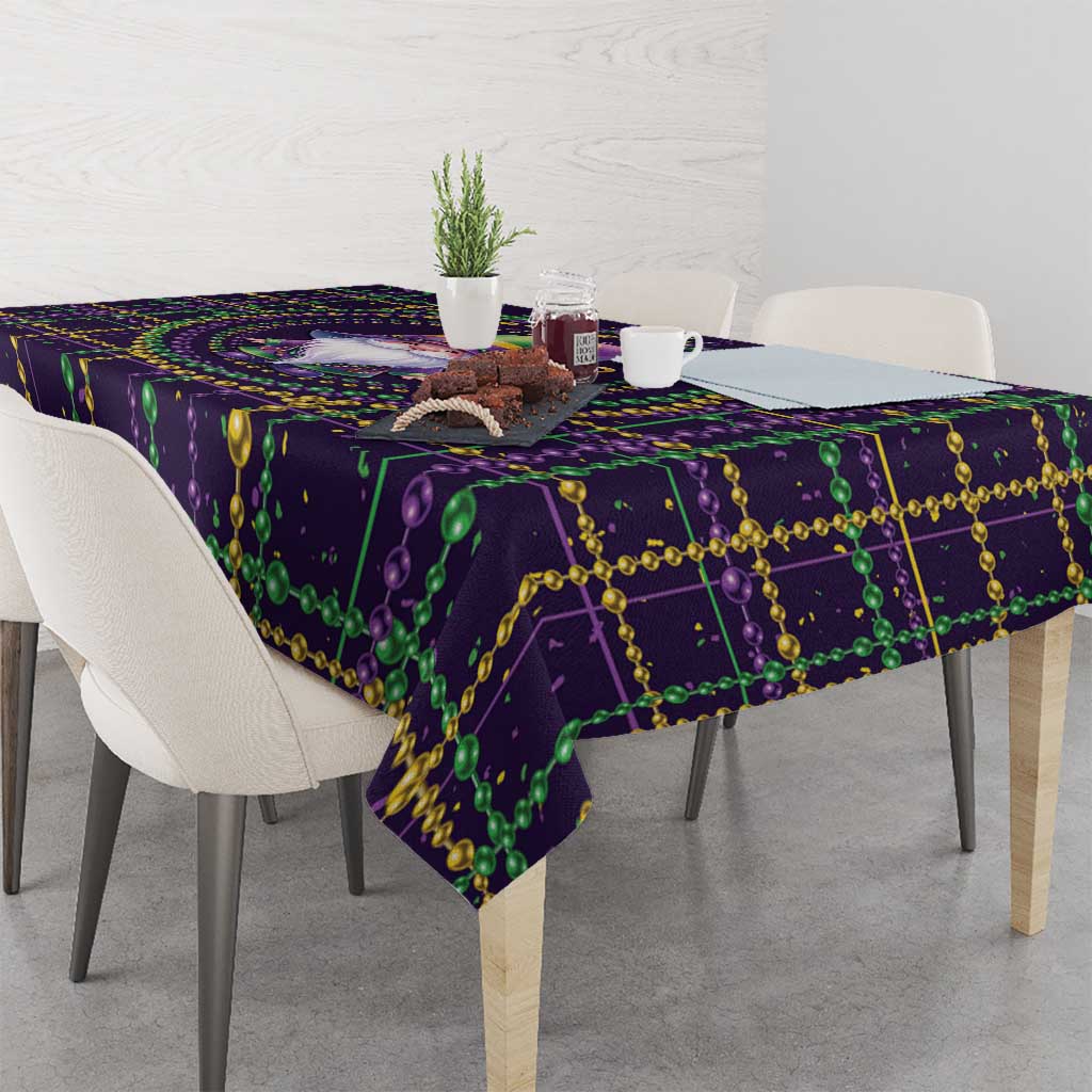 Mardi Gras tablecloth corner with purple geometric print and green bead garland trim