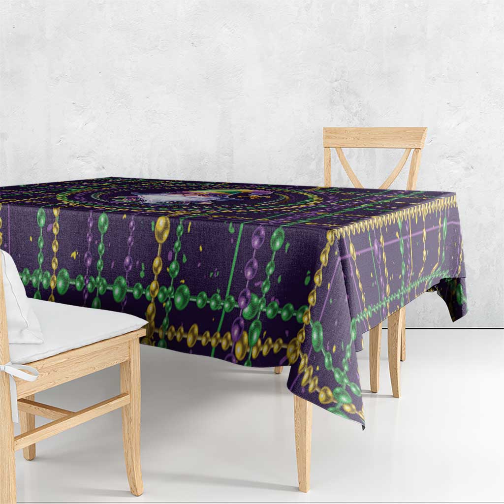 Mardi Gras tablecloth with purple base and green bead garland fringe along edge