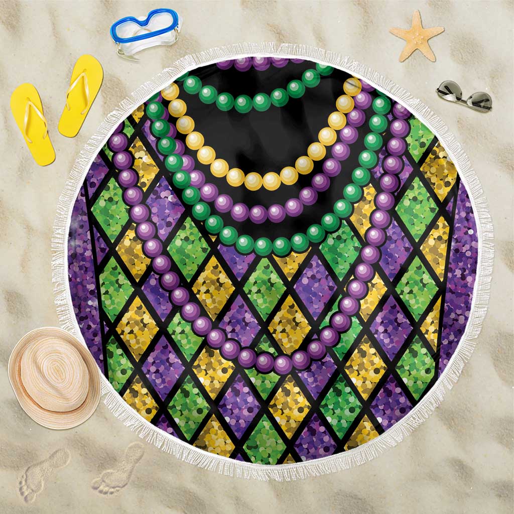 Round beach blanket with purple green yellow bead garlands over multicolor diamond pattern, fringe