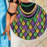 Round beach blanket close-up with purple green yellow bead garlands and multicolor diamond pattern