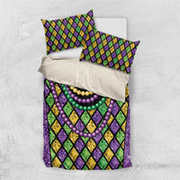 Purple bedding set with diamond pattern and multicolor bead necklaces; duvet and 2 pillowcases