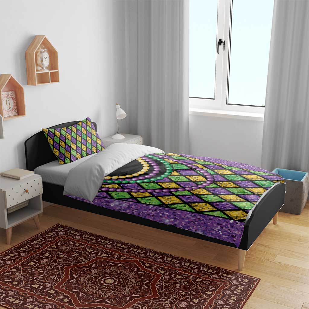 Purple bedding set with diamond pattern and multicolor bead necklaces; duvet and two pillows
