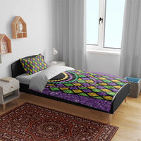 Purple bedding set with diamond pattern and multicolor bead necklaces; duvet and two pillows