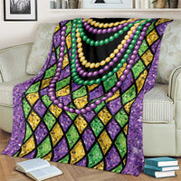 Beads blanket on armchair, purple edge with black center, green and yellow diamonds and bead strands