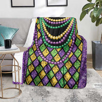Beads blanket folded on couch, multicolor diamond pattern with layered purple, green, and yellow beads