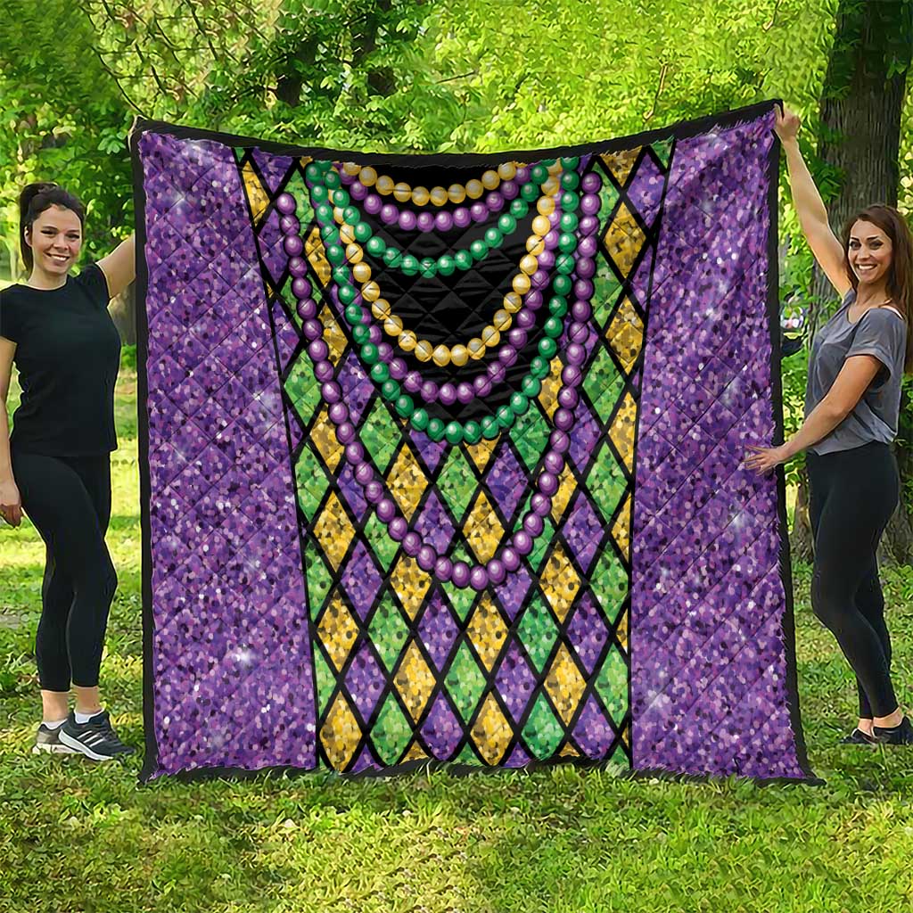 Purple Mardi Gras strings of beads quilt spread out with diamond borders and bead garlands