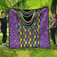 Purple Mardi Gras strings of beads quilt spread out with diamond borders and bead garlands