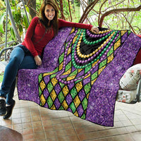 Purple Mardi Gras strings of beads quilt held up showing layered bead necklace pattern