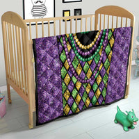 Purple Mardi Gras strings of beads quilt on toddler bed with bead necklace design