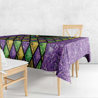 Purple glitter Mardi Gras tablecloth with diamond pattern border and hanging table skirt corners