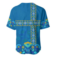 Blue Sweden baseball jersey, back view with yellow patterned cross and floral bird motifs