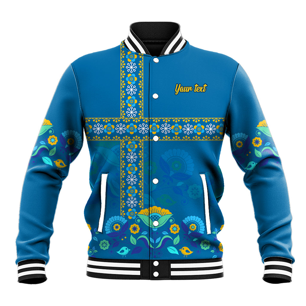 Blue baseball jacket with stand collar, snap buttons, colorful patterned front panel and pockets