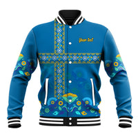 Blue baseball jacket with stand collar, snap buttons, colorful patterned front panel and pockets