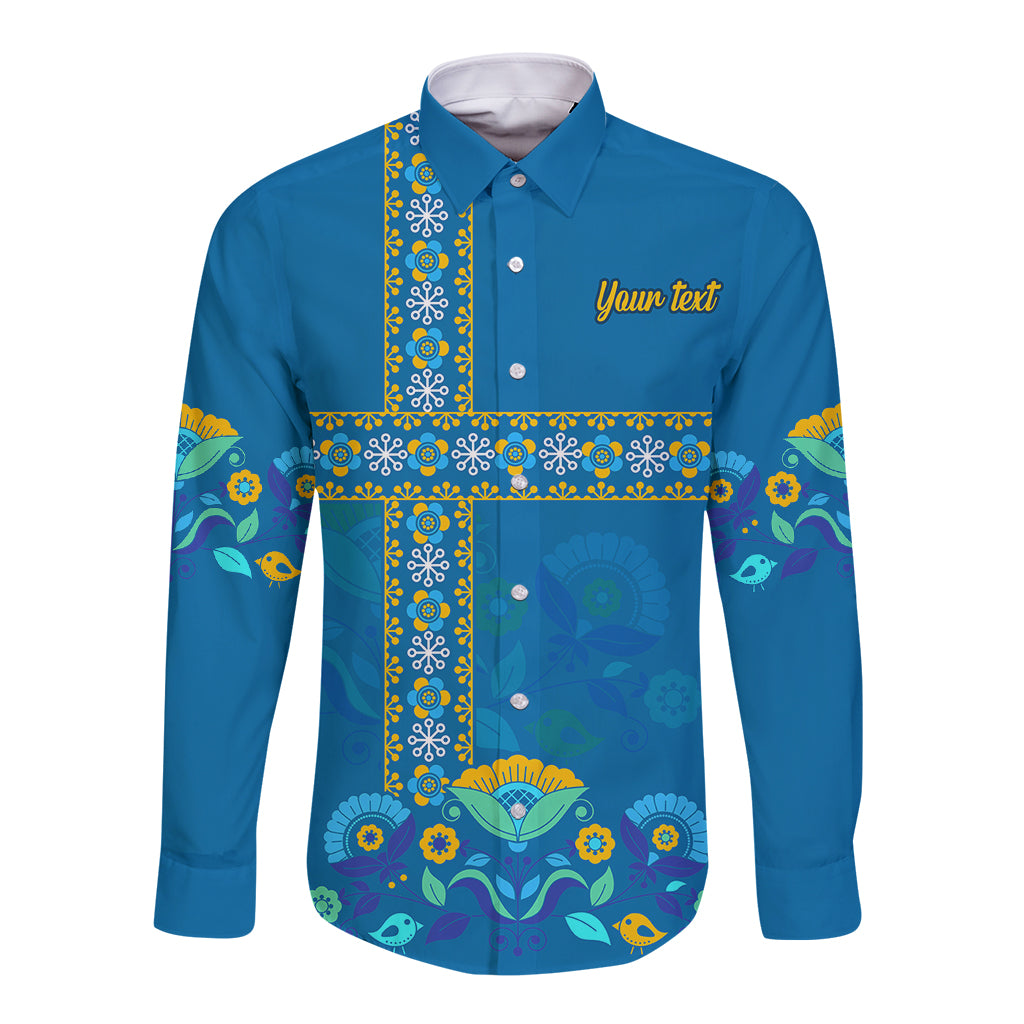 Blue long-sleeve button shirt with colorful Scandinavian folk cross pattern