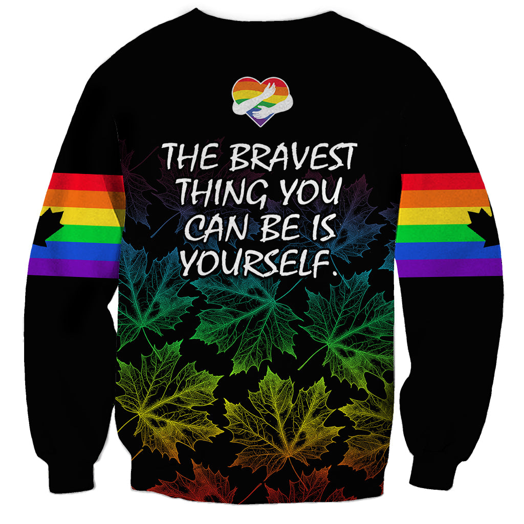 Unisex black sweatshirt with rainbow stripe sleeves and 'THE BRAVEST THING YOU CAN BE YOURSELF' text