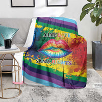 Rainbow lips kiss blanket on gray sofa, colorful lips graphic, rainbow stripes, “Same Love / Same Rights”.