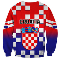 Red crewneck sweatshirt with blue checkerboard pattern and Croatia crest graphic, CROATIA text