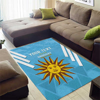 Blue area rug with Uruguay sun emblem, white stripe details, and YOUR TEXT