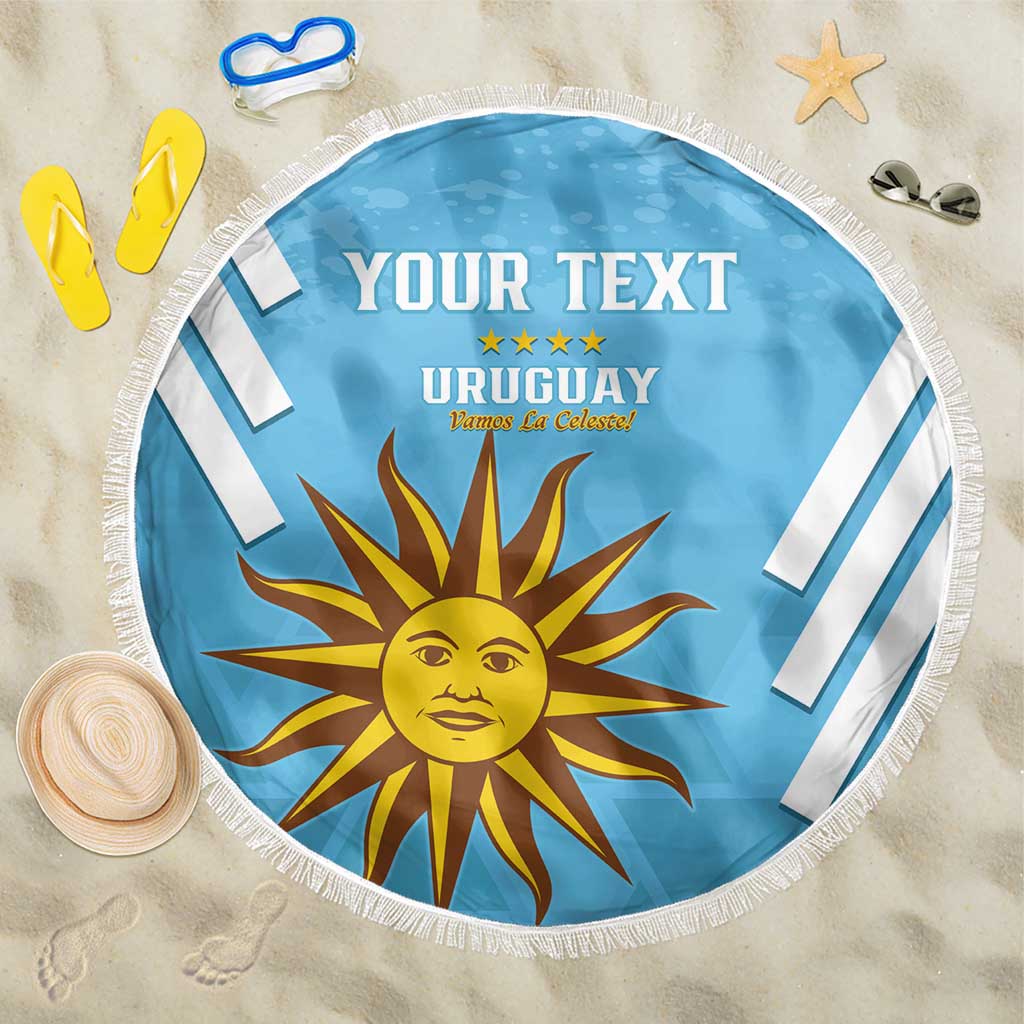 Blue round beach blanket with white fringe, "YOUR TEXT" and Uruguay sun emblem