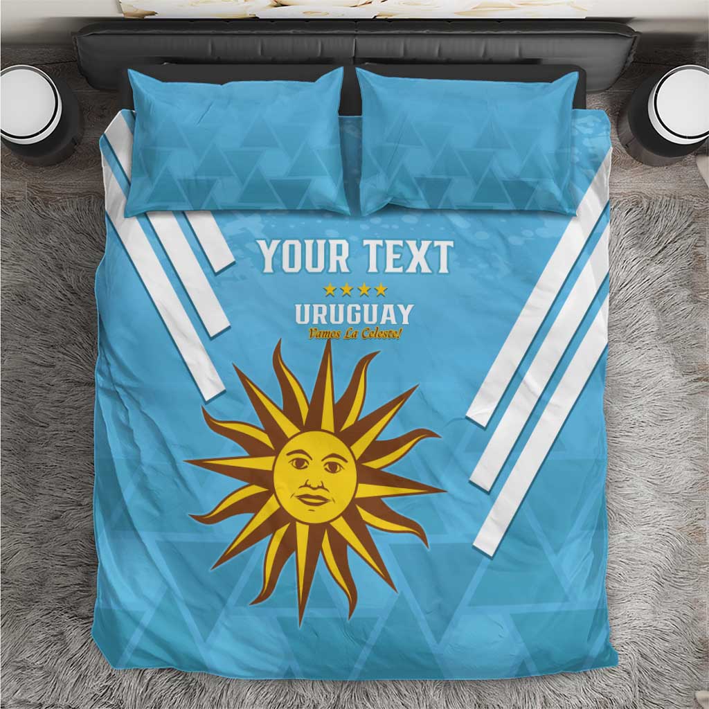 Blue football bedding set with two pillows, Uruguay text, sun emblem, white diagonal stripes