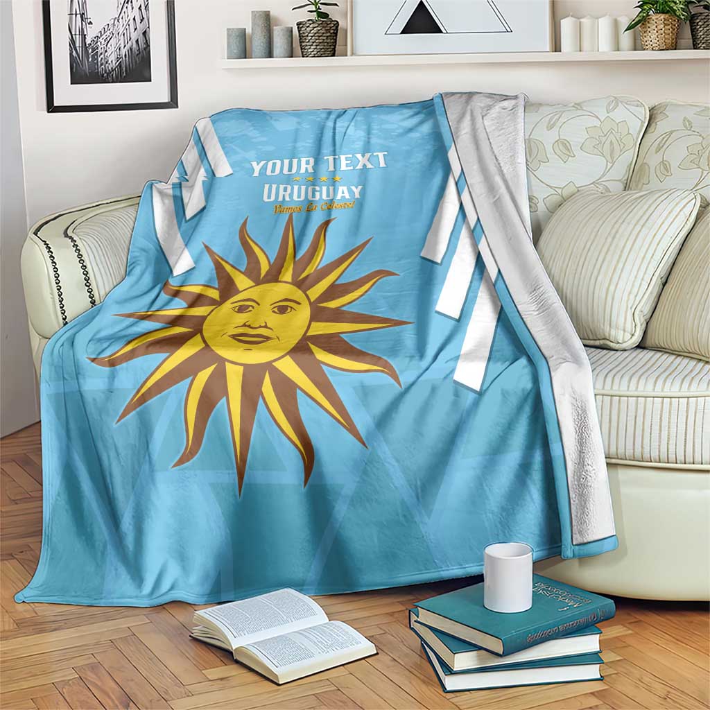 Light blue Uruguay football blanket with white stripes, sun emblem, and YOUR TEXT
