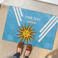 Blue Uruguay football rubber doormat with sun crest, stripe bars, and 'YOUR TEXT' in entry.