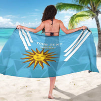 Light blue Uruguay sarong from back with white diagonal stripes, sun emblem, and YOUR TEXT
