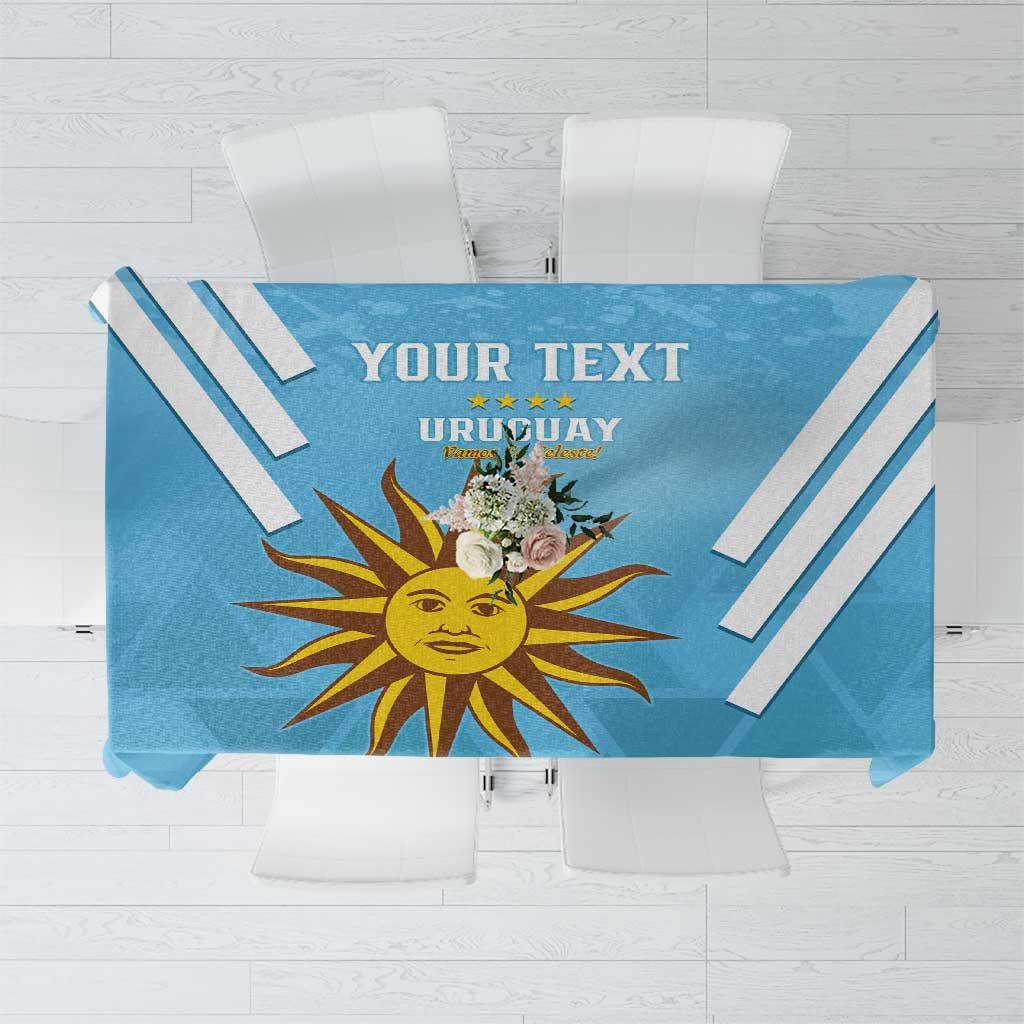 Blue Uruguay-themed tablecloth with sun emblem, diagonal stripes, and customizable text area