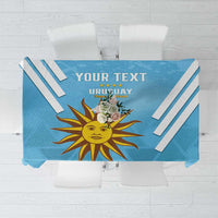 Blue Uruguay-themed tablecloth with sun emblem, diagonal stripes, and customizable text area