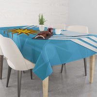 Blue tablecloth with Uruguay sun emblem and bold diagonal stripes over a dining table