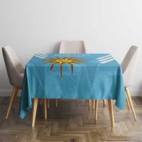 Blue tablecloth with central Uruguay sun star emblem and diagonal stripe accents