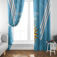 Blue curtains on window with white diagonal stripes and sun Uruguay emblem