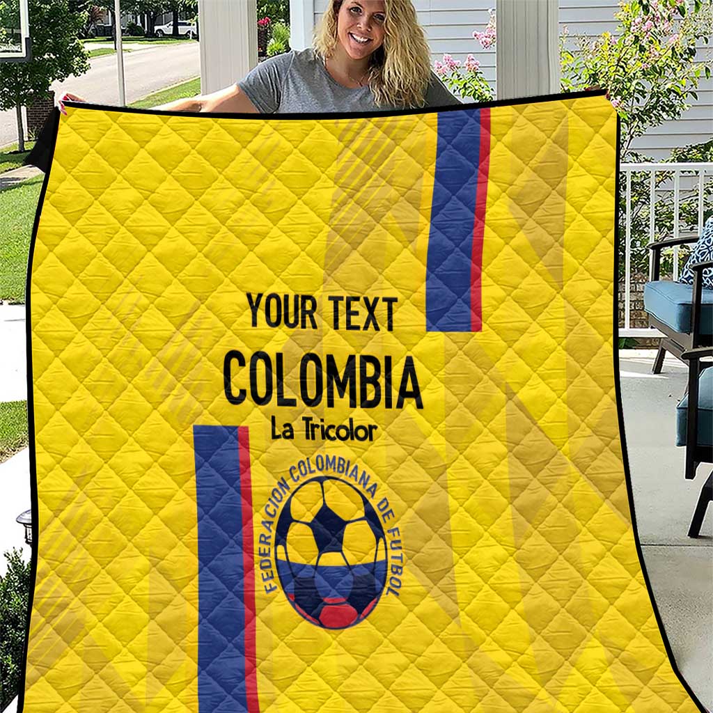 Yellow quilt with diamond stitching, black trim, Colombia text and crest with flag stripe
