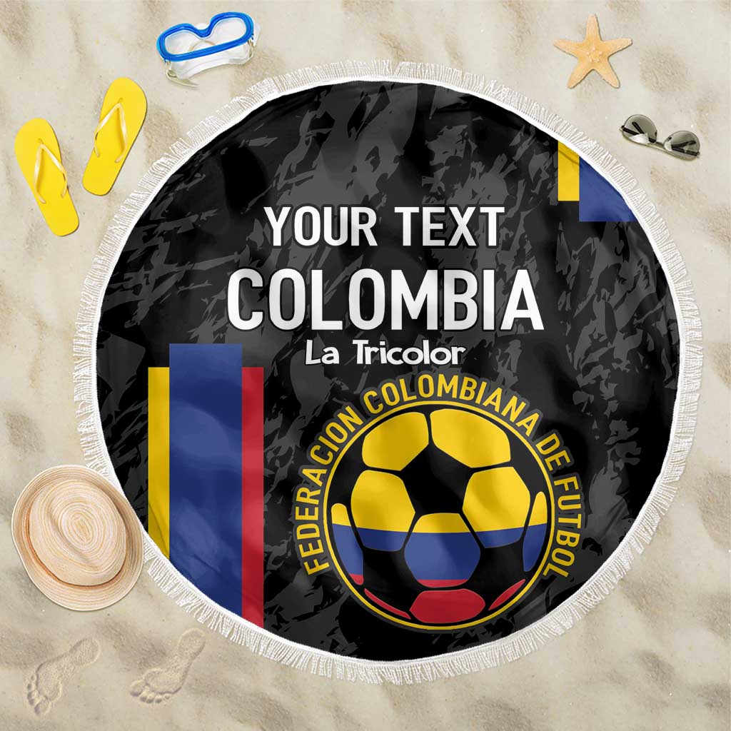 Black round beach blanket with white fringe, soccer crest and vertical Colombia stripes