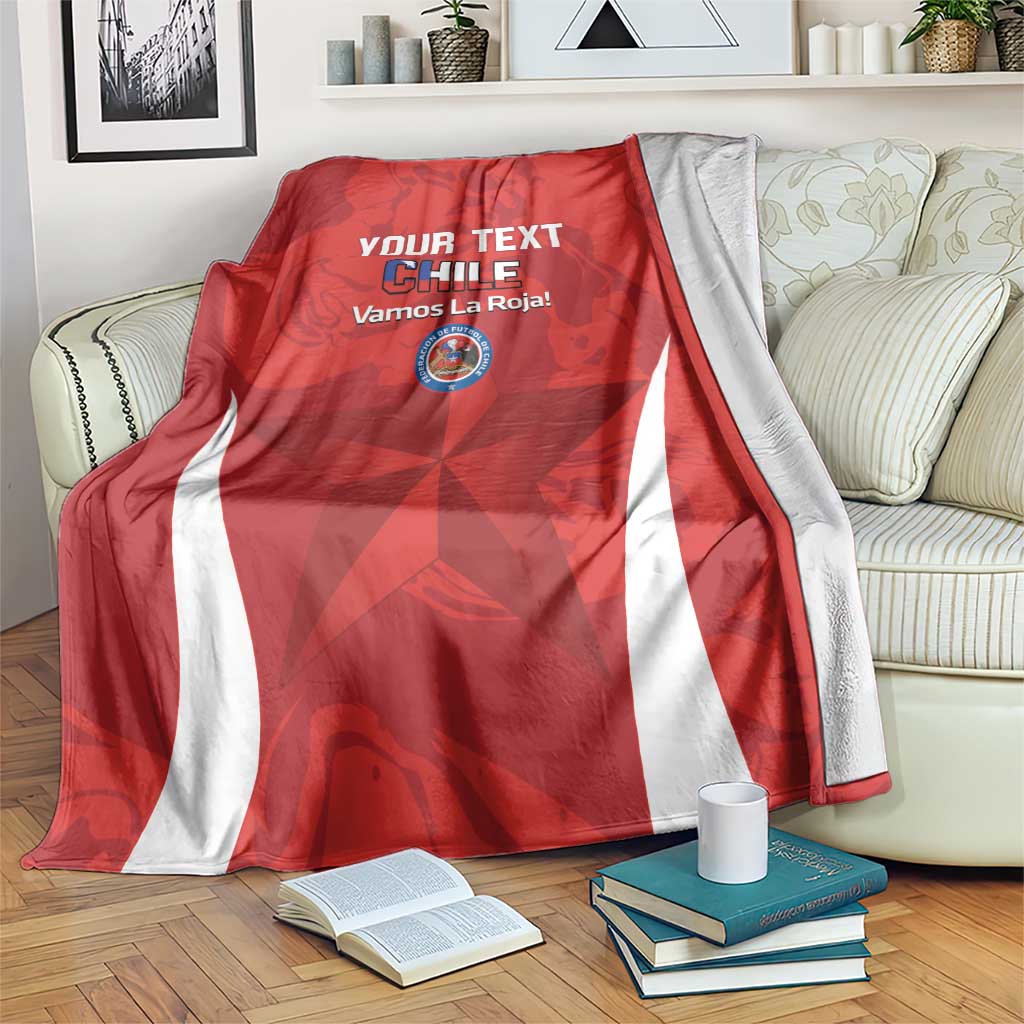 Red Chile-themed football blanket with white side stripes, draped on a sofa.