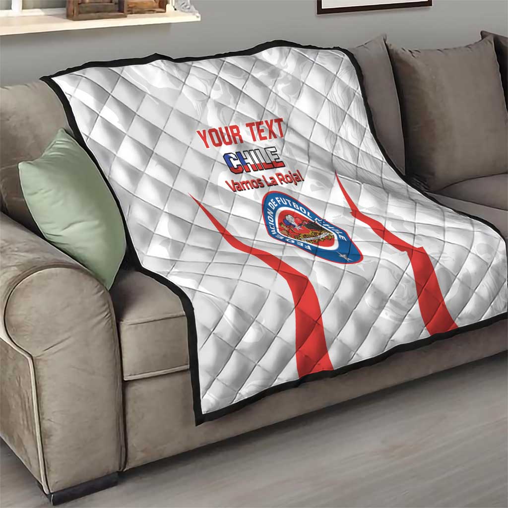 White Chile football quilt on a sofa, red diagonal stripes and central crest graphic