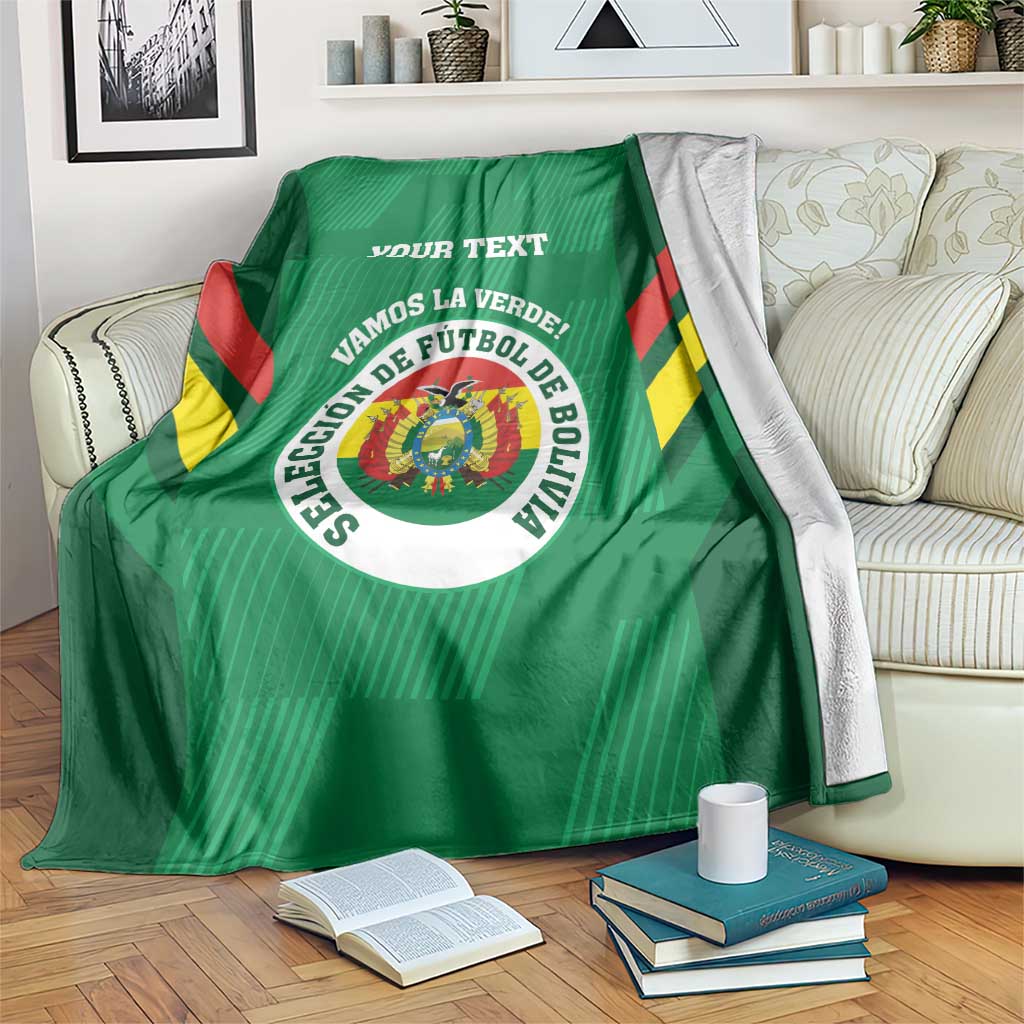 Green custom football blanket draped on sofa, featuring Bolivia crest and ribbon text