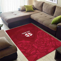 Red area rug with rose pattern and centered circular 'YOUR TEXT' text patch