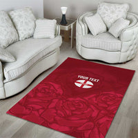 Red area rug featuring rose pattern with a centered circular 'YOUR TEXT' emblem