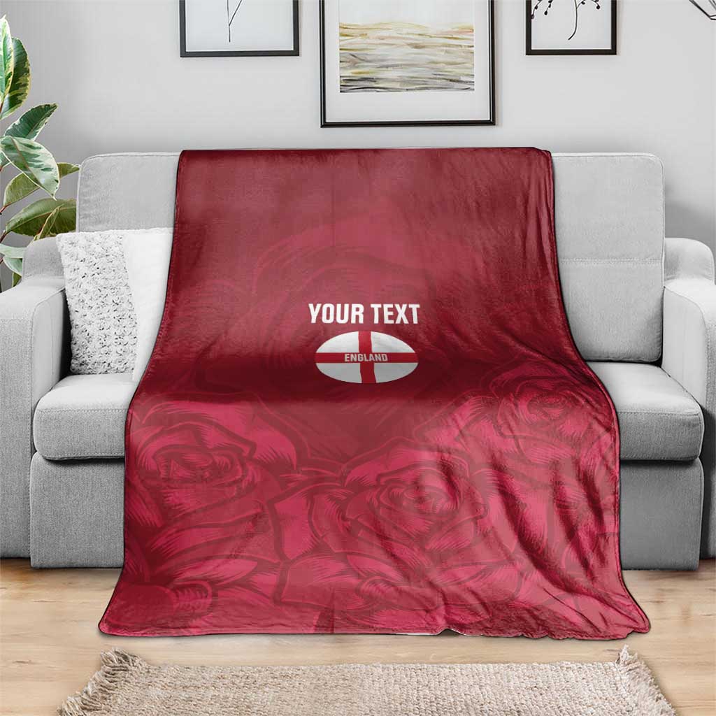 Red England rugby blanket folded on gray sofa, 'YOUR TEXT' and rose design