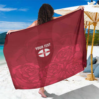 Red England rugby sarong with rose print and circular custom text emblem, draped