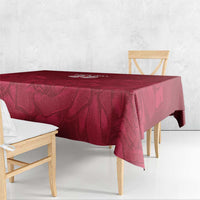 Red rose-pattern tablecloth covering a tabletop with a skirted drape