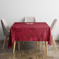 Red rose-pattern tablecloth on a square table with four chairs