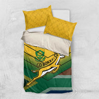 Green and yellow bedding set with white pillow and two yellow pillowcases plus Go Bokke design