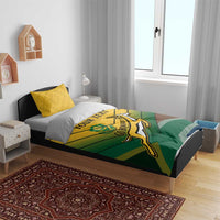 Green and yellow duvet cover with Go Bokke crest on bed, paired with white and yellow pillows