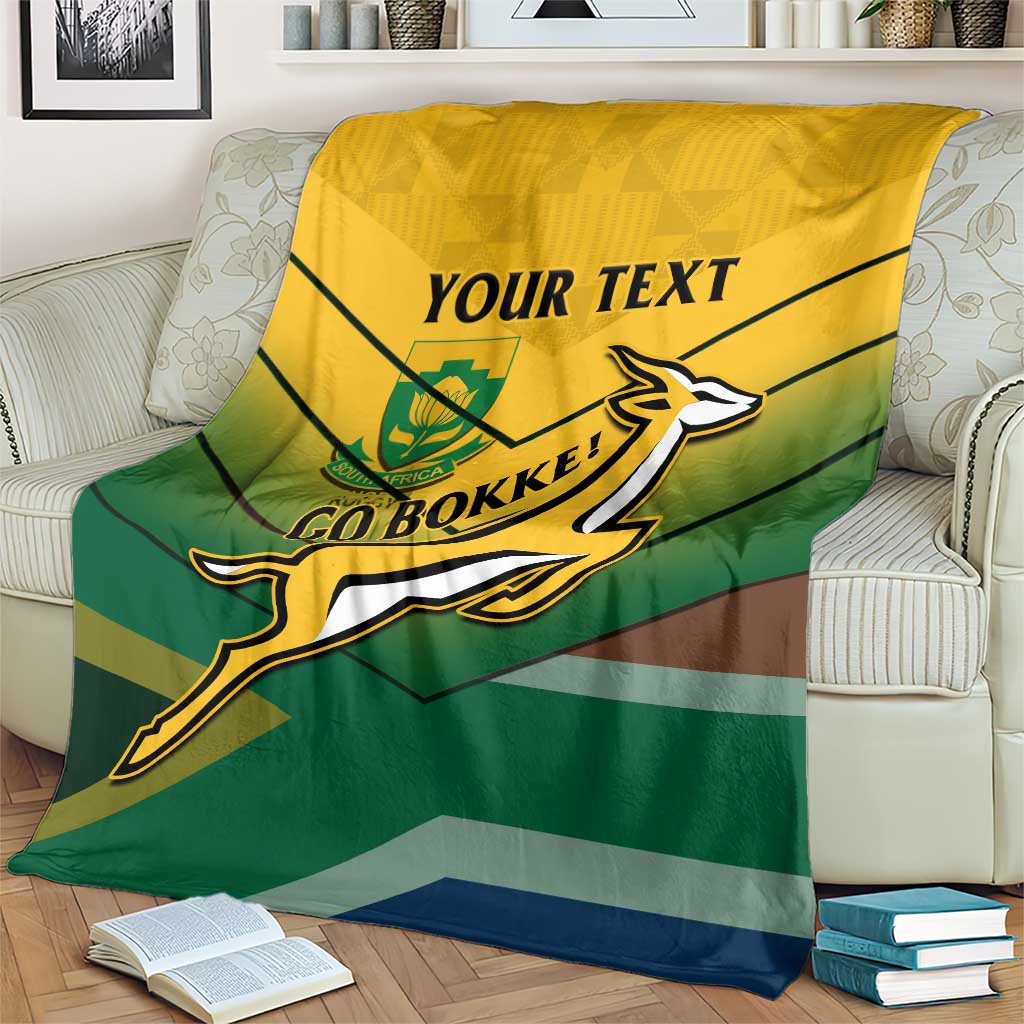 South Africa rugby blanket on beige couch, yellow top, green stripes, Go Bokke logo