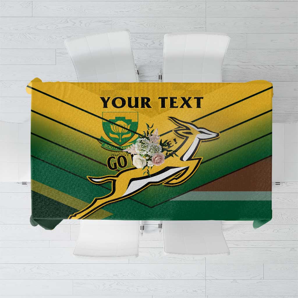 Green tablecloth with yellow GO graphic and multicolor striped design