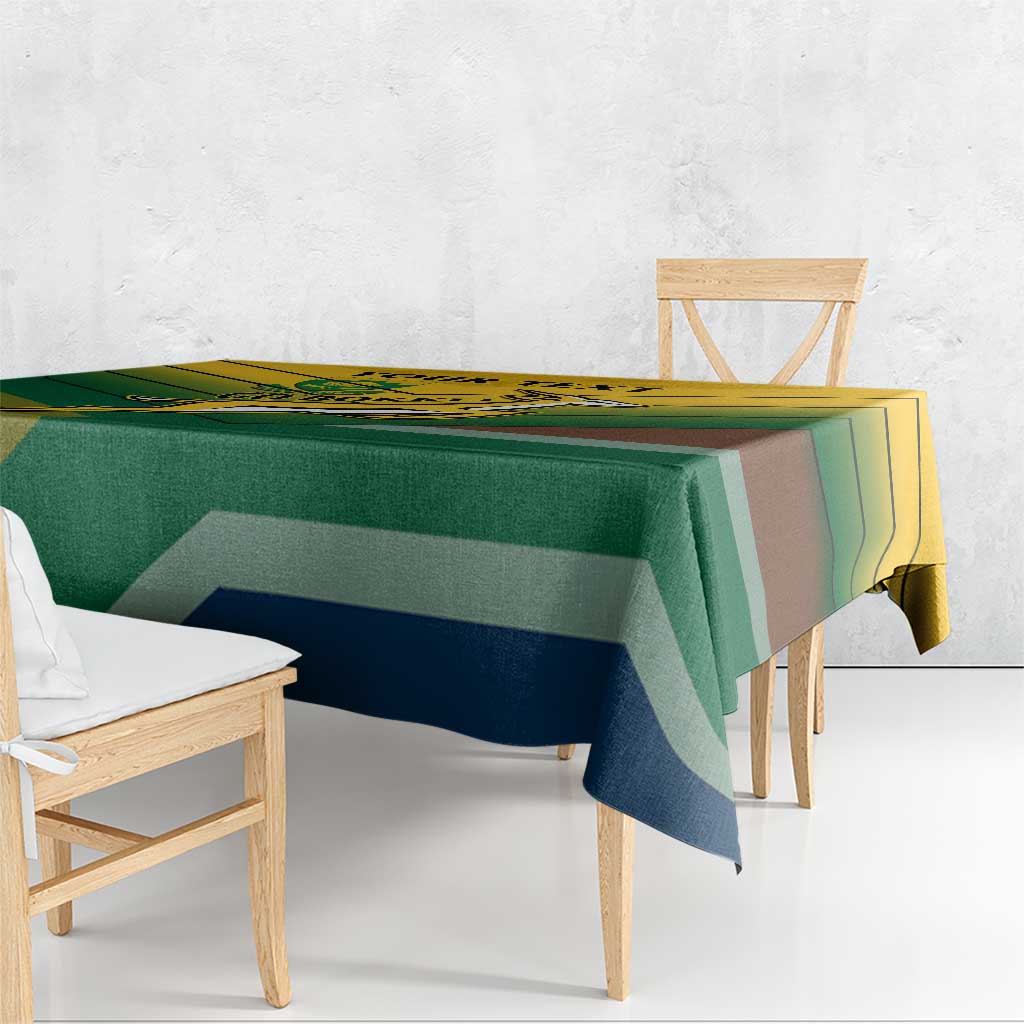 Green tablecloth with diagonal stripe pattern in yellow, blue, and brown