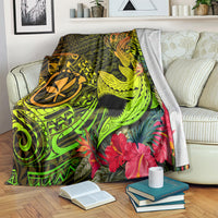 Polynesian shark tattoo blanket on bed, neon green and gold map design with pink hibiscus
