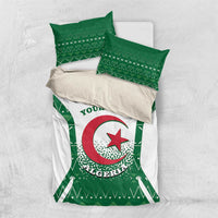Personalized bedding set laid out: white duvet with green Algeria crest print and pillowcases